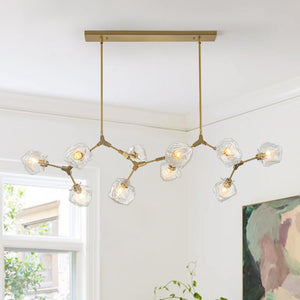 Indulge in the captivating allure of our Glam Modern Branching Ice Glass Shade Chandelier, an embodiment of modern elegance that enhances any space with its striking branching design. Meticulously crafted from sleek metal in a polished brass finish, this fixture features an ice-style glass design with branching arms that gracefully fan outward in multiple directions.